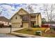 Two-story home with a two-car garage, front lawn and a combination of stone and siding at 963 Ensign Peak Ct, Lawrenceville, GA 30044