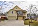 Charming two-story home boasts a stone and siding facade, two-car garage, and well-manicured lawn at 963 Ensign Peak Ct, Lawrenceville, GA 30044