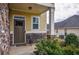 Charming front porch featuring a decorative bench, stone accents, and a well-maintained garden at 963 Ensign Peak Ct, Lawrenceville, GA 30044