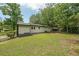 Back of house showcasing a large, grassy backyard with treeline and partially fenced perimeter at 2621 Gordon Se Cir, Smyrna, GA 30080