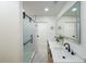 Bathroom featuring double vanity with modern fixtures and a glass-enclosed shower with black hardware at 2621 Gordon Se Cir, Smyrna, GA 30080