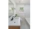 Modern bathroom features a large vanity, matte black faucet, and shower/tub combo at 2621 Gordon Se Cir, Smyrna, GA 30080