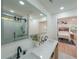 Bright bathroom boasts a double vanity with modern fixtures, a large mirror, and a glass shower at 2621 Gordon Se Cir, Smyrna, GA 30080