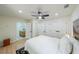 A bright bedroom featuring neutral decor, including a ceiling fan and a bathroom entrance to the left at 2621 Gordon Se Cir, Smyrna, GA 30080