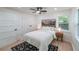 Bright bedroom with white walls, a ceiling fan, and light wood floors; decorated with mountain-themed art at 2621 Gordon Se Cir, Smyrna, GA 30080