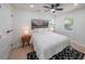 Well-lit bedroom with a ceiling fan, black and white rug, and landscape art above the bed at 2621 Gordon Se Cir, Smyrna, GA 30080