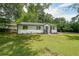 Front yard of a single-story home with a well-manicured lawn and black mulch at 2621 Gordon Se Cir, Smyrna, GA 30080