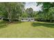 Spacious front yard of a single-story home with mature trees and a green lawn at 2621 Gordon Se Cir, Smyrna, GA 30080