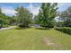 Expansive front yard view of a single-story home with mature trees and a lush lawn at 2621 Gordon Se Cir, Smyrna, GA 30080