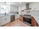 Bright kitchen features stainless appliances, white cabinets, and modern range hood at 2621 Gordon Se Cir, Smyrna, GA 30080