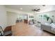 Open-concept living room with wood floors, modern furniture, and connecting to the dining room at 2621 Gordon Se Cir, Smyrna, GA 30080