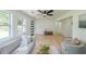 Bright living room with light wood floors, modern furnishings, ceiling fan, and large windows at 2621 Gordon Se Cir, Smyrna, GA 30080