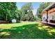 Large, grassy backyard with a storage shed and covered patio area, perfect for outdoor activities and relaxation at 630 Beckenham Walk Dr, Dacula, GA 30019