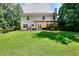 Expansive backyard featuring a covered patio, lush lawn, and well-maintained perimeter fence providing plenty of space and privacy at 630 Beckenham Walk Dr, Dacula, GA 30019