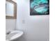 Functional bathroom with a sink and artistic wall decor, offering a blend of practicality and aesthetic appeal at 630 Beckenham Walk Dr, Dacula, GA 30019