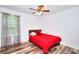 This cozy bedroom features a ceiling fan, and a window with beautiful neutral curtains at 630 Beckenham Walk Dr, Dacula, GA 30019