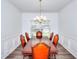 Dining room with a wooden table and chairs with a window view and decorative molding at 630 Beckenham Walk Dr, Dacula, GA 30019