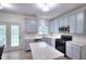 Modern kitchen with stainless steel appliances, stylish cabinets, quartz countertops and door to the outside at 630 Beckenham Walk Dr, Dacula, GA 30019