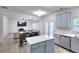 Bright kitchen with new countertops, stainless appliances and an island, opening to the dining and Gathering room at 630 Beckenham Walk Dr, Dacula, GA 30019