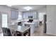 Updated kitchen with modern cabinets, stainless steel appliances, island, and adjacent dining area at 630 Beckenham Walk Dr, Dacula, GA 30019