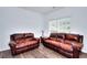 Inviting living room featuring two comfortable leather sofas, perfect for relaxing with Gathering and friends at 630 Beckenham Walk Dr, Dacula, GA 30019