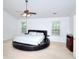 Main bedroom features a round bed, ceiling fan, and natural light, creating a luxurious and comfortable retreat at 630 Beckenham Walk Dr, Dacula, GA 30019