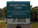 Sign for Rabbit Hill Park with Gwinnett County Parks information and listing fall registration at 630 Beckenham Walk Dr, Dacula, GA 30019