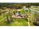 Aerial view of Rabbit Hill Park featuring a playground, picnic areas, walking trails, and sports courts for recreation at 630 Beckenham Walk Dr, Dacula, GA 30019