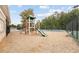 Community playground featuring a slide, climbing structures, and swing set within a safety-conscious wood-chip surface at 630 Beckenham Walk Dr, Dacula, GA 30019