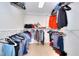 Spacious walk-in closet provides ample storage with built in organizers, shelves, and hanging rods at 630 Beckenham Walk Dr, Dacula, GA 30019