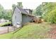 View of the home's backyard with a wooden deck and stairs, plus lawn and partial fence at 859 Sangria Ct, Lawrenceville, GA 30043