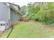 A home's backyard with a wooden deck, lawn, and a partial fence at 859 Sangria Ct, Lawrenceville, GA 30043