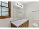 Well-lit bathroom featuring a large vanity, mirror, and a window, creating a bright and functional space at 859 Sangria Ct, Lawrenceville, GA 30043
