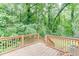 A wooden deck overlooks a lush green forest backdrop at 859 Sangria Ct, Lawrenceville, GA 30043