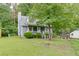 Charming blue home with a well-manicured lawn and mature trees at 859 Sangria Ct, Lawrenceville, GA 30043