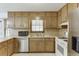 Traditional kitchen featuring wood cabinets and stainless steel appliances at 859 Sangria Ct, Lawrenceville, GA 30043