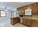 Traditional kitchen featuring wood cabinets, peninsula counter and sink with a view at 859 Sangria Ct, Lawrenceville, GA 30043