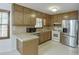 Traditional kitchen featuring wood cabinets and stainless steel appliances at 859 Sangria Ct, Lawrenceville, GA 30043