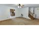 Spacious living room with ceiling fan adjacent to kitchen and staircase at 859 Sangria Ct, Lawrenceville, GA 30043