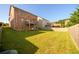 Spacious backyard featuring a brick house with a wooden deck and a well-maintained lawn, perfect for outdoor activities at 1021 Reddy Farm Rd, Grayson, GA 30017