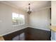 Dining room with dark wood floors, chandelier, and natural light from window at 1021 Reddy Farm Rd, Grayson, GA 30017