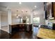 Modern kitchen with stainless appliances and granite countertops overlooks the living area at 1021 Reddy Farm Rd, Grayson, GA 30017