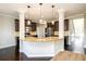 Gourmet kitchen featuring granite countertops, stainless steel appliances, and pendant lighting over a breakfast bar at 1021 Reddy Farm Rd, Grayson, GA 30017