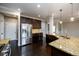 Open concept kitchen with granite countertops, stainless appliances, and dark wood flooring at 1021 Reddy Farm Rd, Grayson, GA 30017