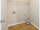 Practical laundry room with tile flooring and storage shelf at 1021 Reddy Farm Rd, Grayson, GA 30017