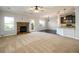 Cozy living room featuring a fireplace, neutral carpet, and an open floor plan with access to the kitchen at 1021 Reddy Farm Rd, Grayson, GA 30017