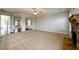 Large open living room with a stone fireplace, neutral carpet, and seamless transitions to the dining area at 1021 Reddy Farm Rd, Grayson, GA 30017