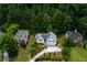 Aerial view showcasing a beautifully landscaped home and surrounding trees at 2111 Yorkshire Ct, Woodstock, GA 30189
