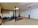 Finished basement area with exercise equipment, TV, and space for activities at 2111 Yorkshire Ct, Woodstock, GA 30189