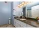 Elegant bathroom featuring granite countertops, white cabinets, stylish fixtures, and neutral tile flooring at 2111 Yorkshire Ct, Woodstock, GA 30189